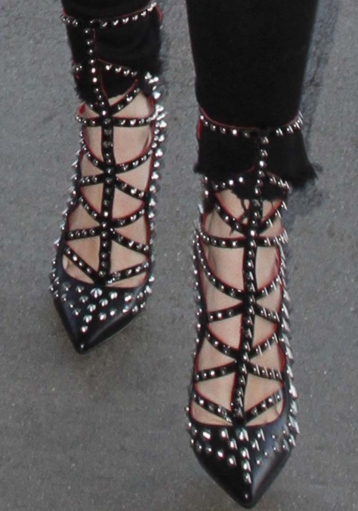 Bella Thorn's feet in studded Cesare Paciotti pumps