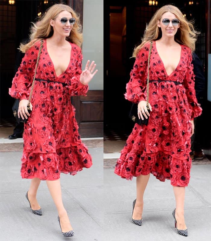 Blake Lively radiates confidence in a striking red floral dress with a deep V-neckline, effortlessly pairing it with chic patterned pumps while out in New York City