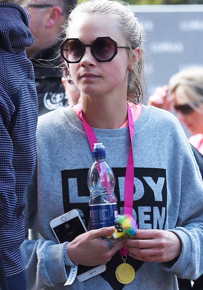 Cara Delevingne ties her hair back in a sporty ponytail for Lady Garden's 5K run