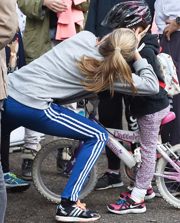 Cara Delevingne goofs around with a child before the 5K run
