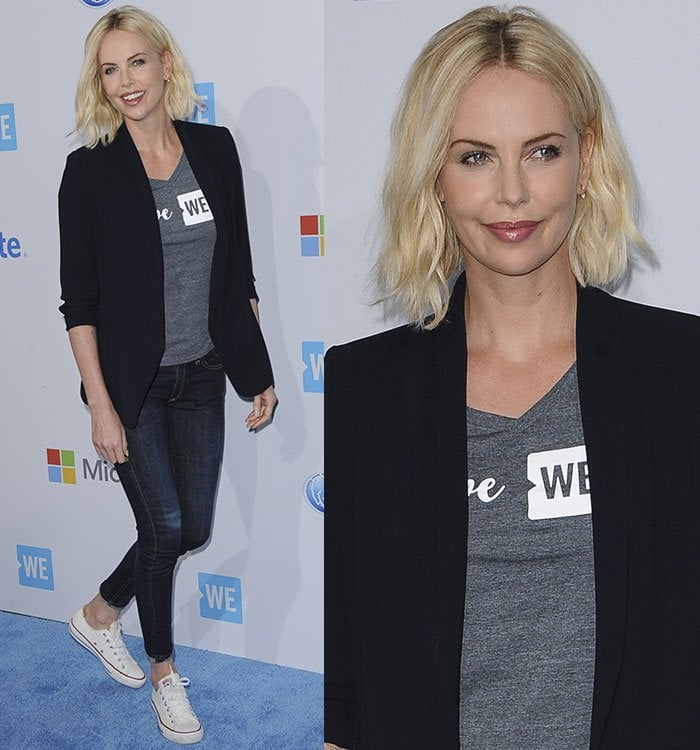 Charlize Theron's black blazer, gray top, and denim jeans