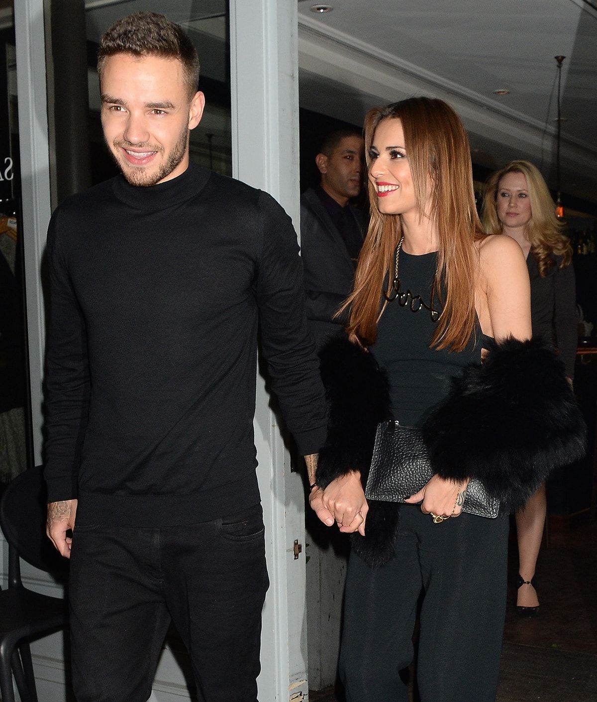 Liam Payne and Cheryl step out hand-in-hand for a night out, both dressed in stylish black ensembles, exuding effortless elegance