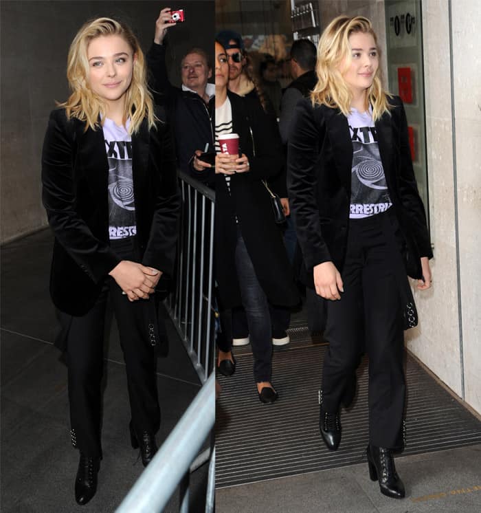 Chloë Grace Moretz showcases a chic and edgy style with suspender pants, an extraterrestrial graphic t-shirt, a black velvet jacket, and lace-up booties