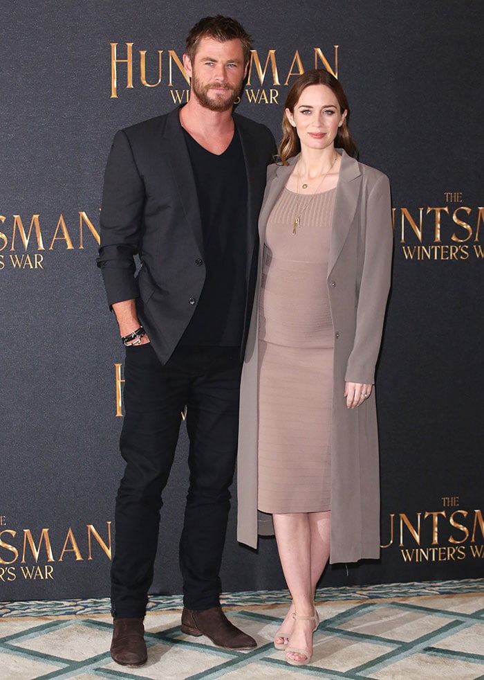 Chris Hemsworth poses with a pregnant Emily Blunt at the premiere of their latest movie