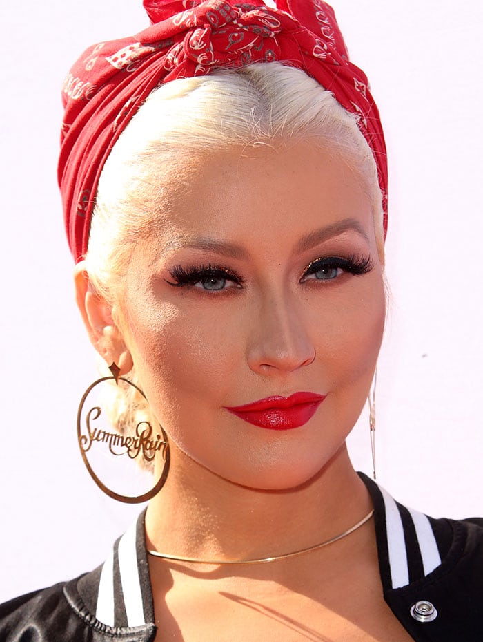 Christina Aguilera wears a Rosie the Riveter hairstyle