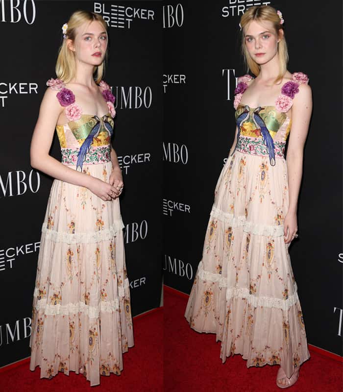 Elle Fanning embraces ethereal femininity in a whimsical floral gown adorned with delicate appliqués, radiating a fairy-tale charm at the premiere of 'Trumbo'