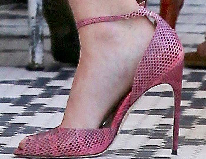 Ellen Pompeo wears Brian Atwood's "Oriana" ankle strap pumps in a pink reptile print