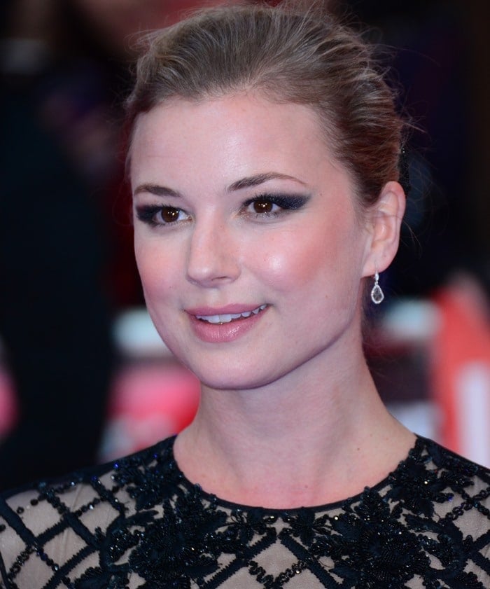 Emily VanCamp pulls her hair back at the premiere of "Captain America: Civil War"