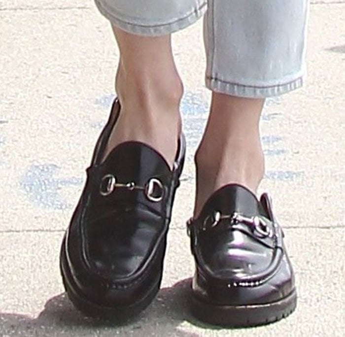 Emma Roberts's feet in black Gucci loafers