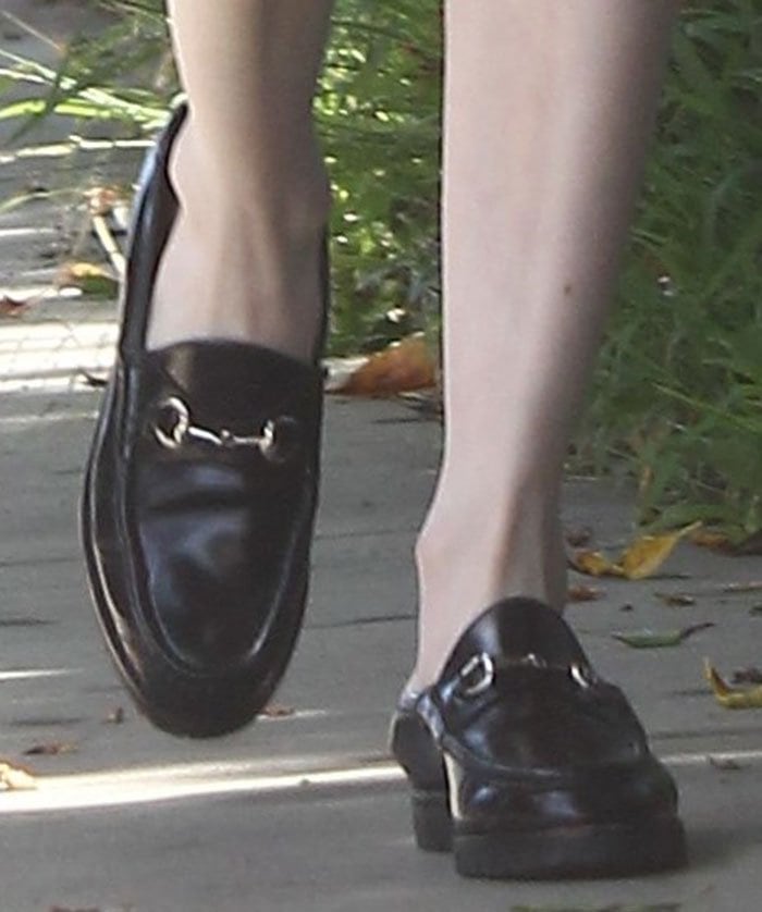 Emma Roberts's feet in leather Gucci loafers