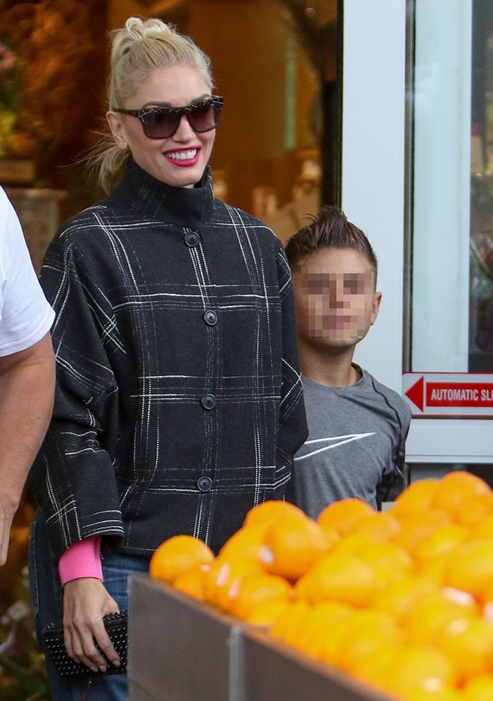 Gwen Stefani wears a black-and-white coat while out shopping with her sons