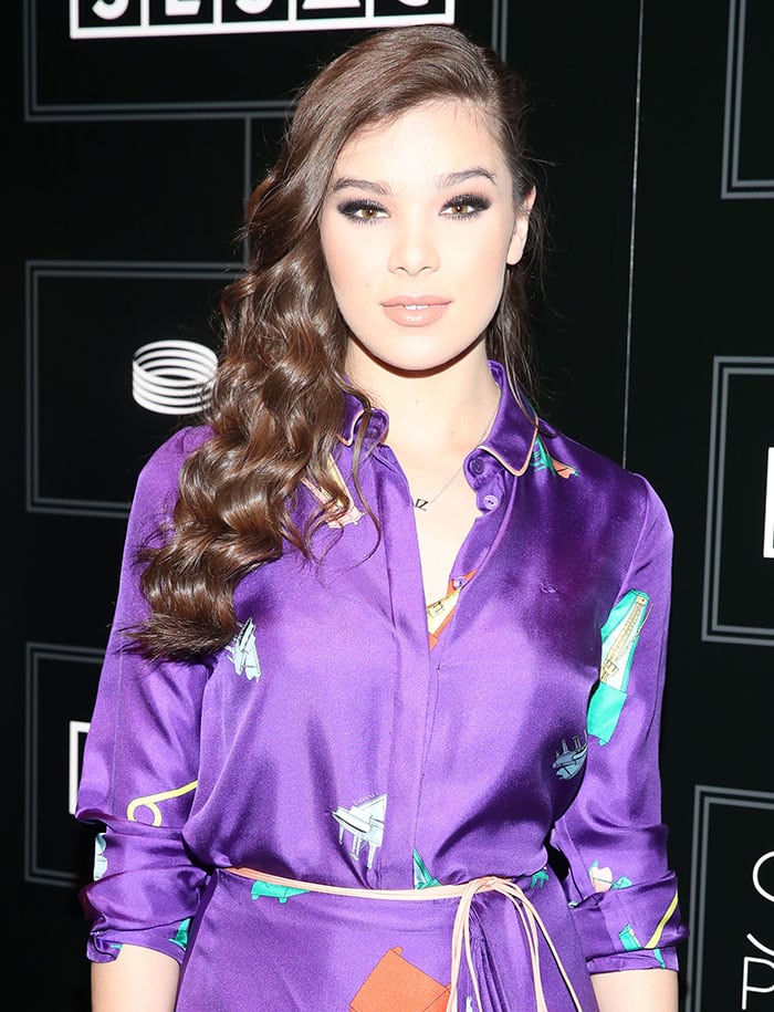 Hailee Steinfeld curls her hair at the 2016 SESAC Pop Music Awards