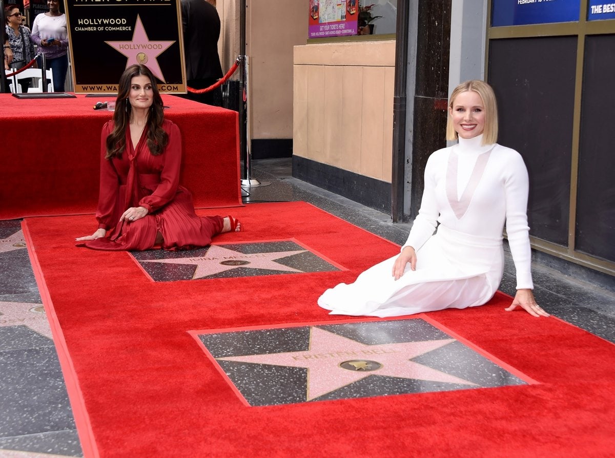 "Frozen" co-stars Idina Menzel and Kristen Bell sit next to their stars on the Hollywood Walk of Fame during an unveiling ceremony