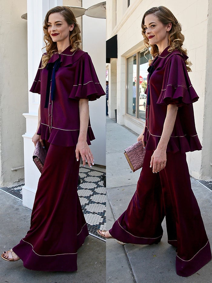 Jaime King wears a maroon satin set with wide legs and ruffled sleeves