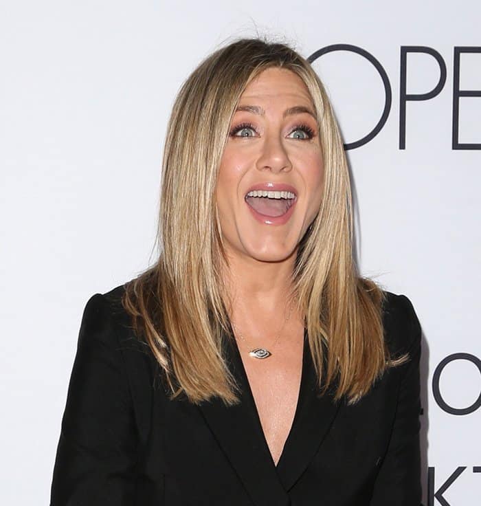 Chic Redefined: Jennifer Aniston in a sleek, blazer-inspired dress, exemplifying understated glamour at the 'Mother's Day' event
