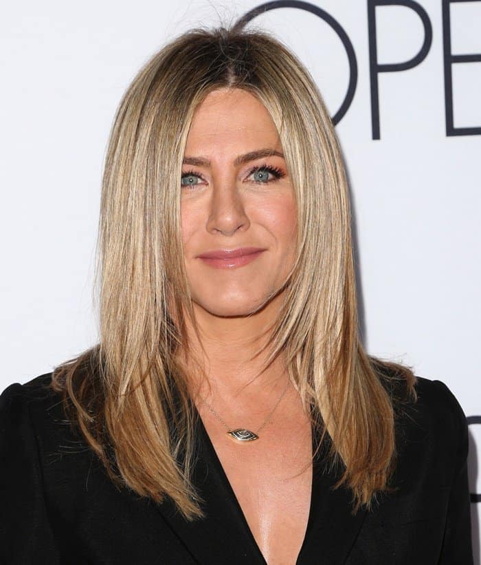 Symbolic Elegance: Jennifer Aniston adorned in the mystical 3rd Eye Collection necklace from Amrit Jewelry, adding a touch of intrigue