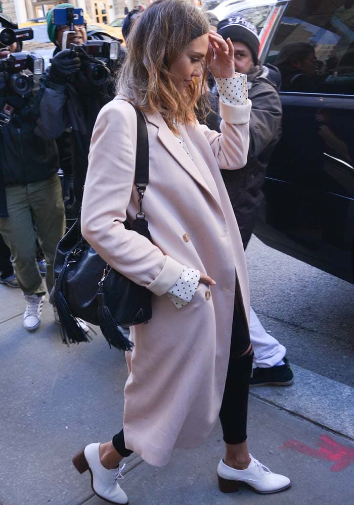 Jessica Alba wears DL1961 jeans and a blush pink Brock Collection coat