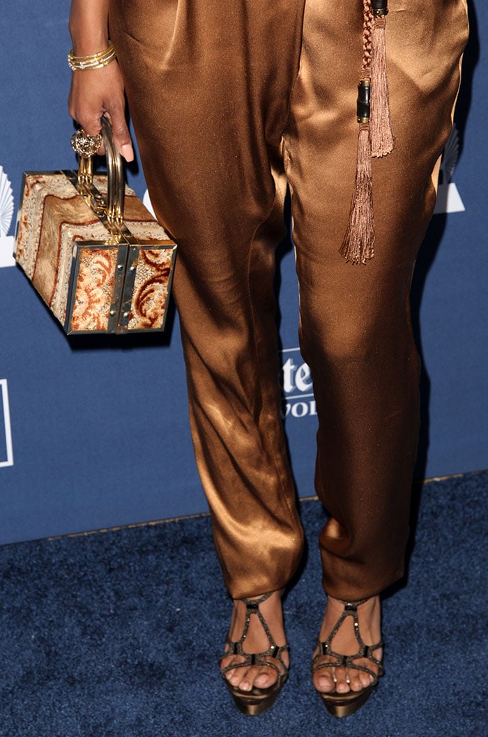 Kat Graham accessorizes with a boxy purse, a large H. Stern ring and bracelets from Jude Frances and Maxior