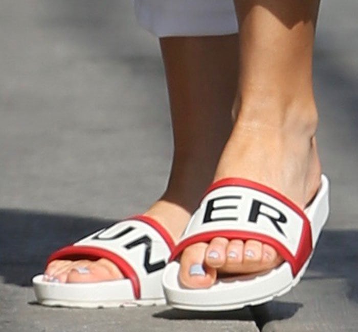 Kate Hudson's feet in red, black and white Hunter slide sandals