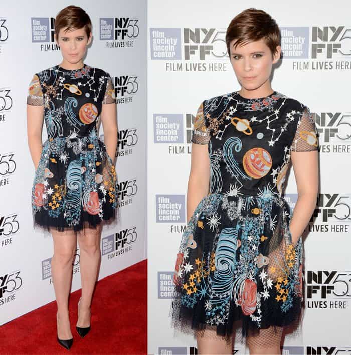 Kate Mara exudes a playful charm in this celestial-themed dress, featuring intricate planetary and star motifs, paired with classic black pumps at the NYFF event