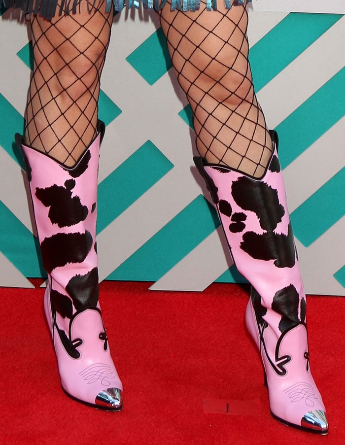 Katy Perry's feet in pink-and-black cow-printed Jeremy Scott cowboy boots