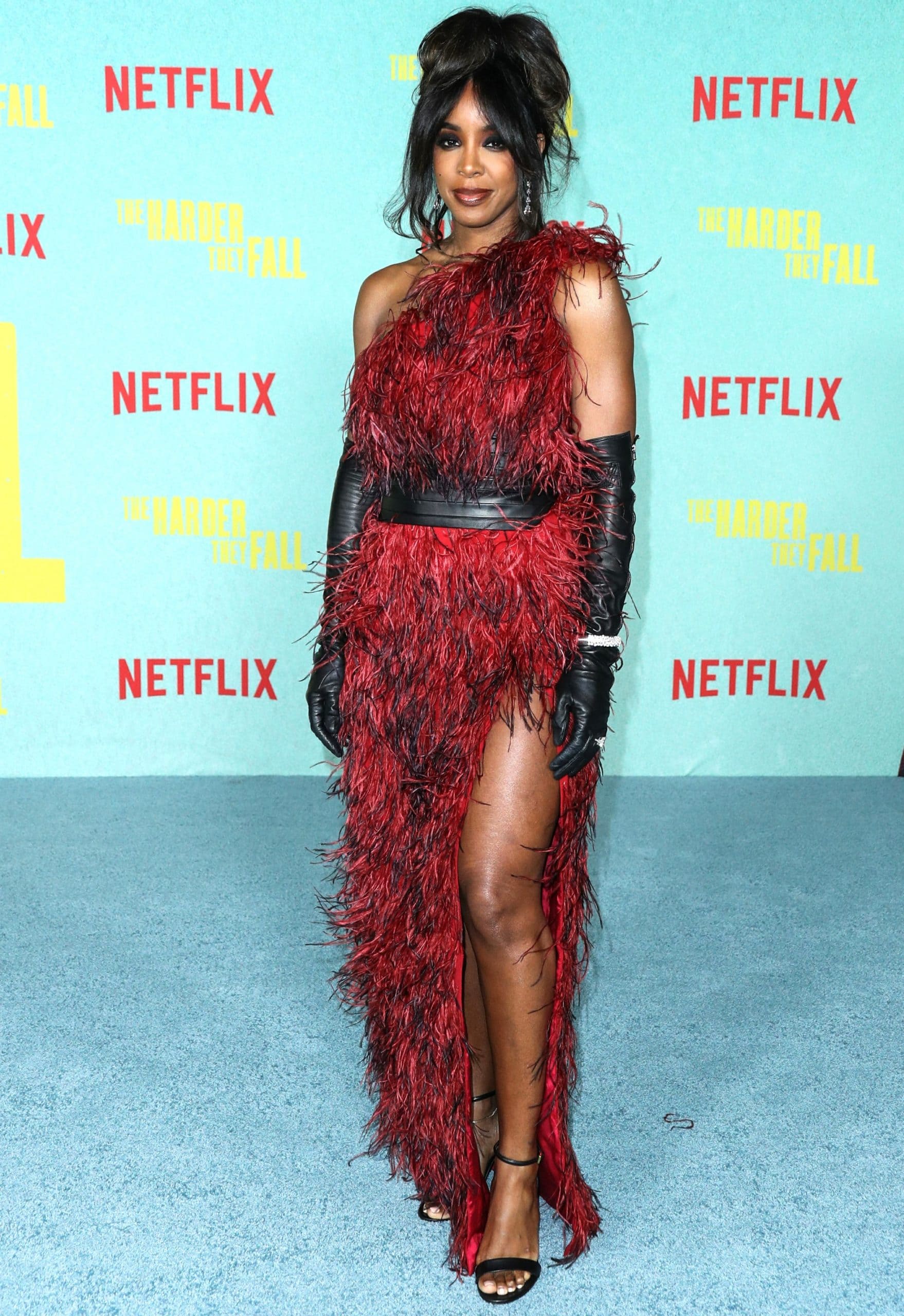Kelly Rowland in a red Marcell Von Berlin Fall/Winter 2021 feather gown and jewelry from Gismondi