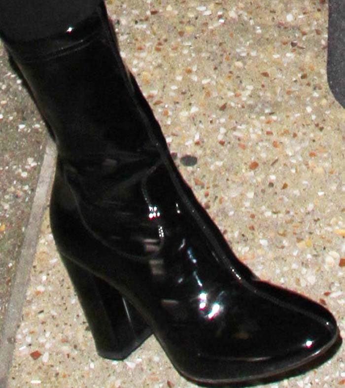 Kendall wears a pair of black patent Kenneth Cole boots