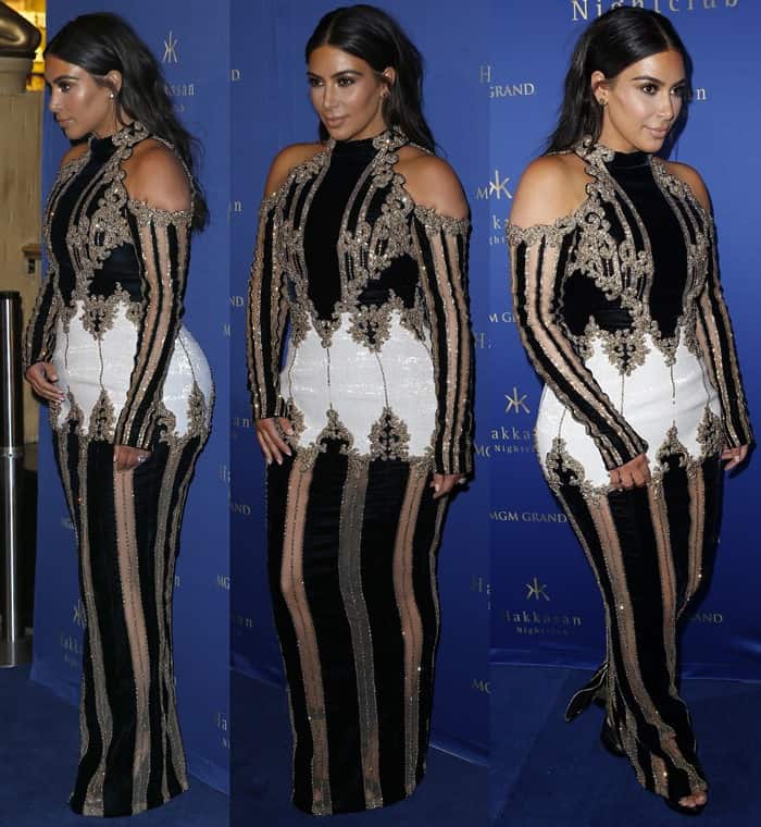 Kim Kardashian's dress features a striking combination of black, white, and gold embellishments in an ornate pattern