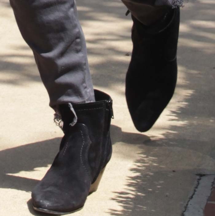 Kourtney Kardashian steps out in her go-to Saint Laurent suede boots, adding a sleek edge to her casual errand-day look