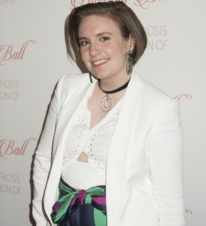 Lena Dunham in a white blazer with a matching lattice cut-out crop top