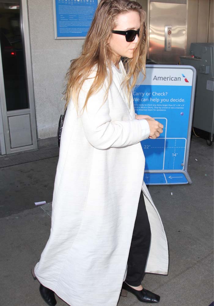 Mary-Kate Olsen wears a full-length coat as she arrives at LAX