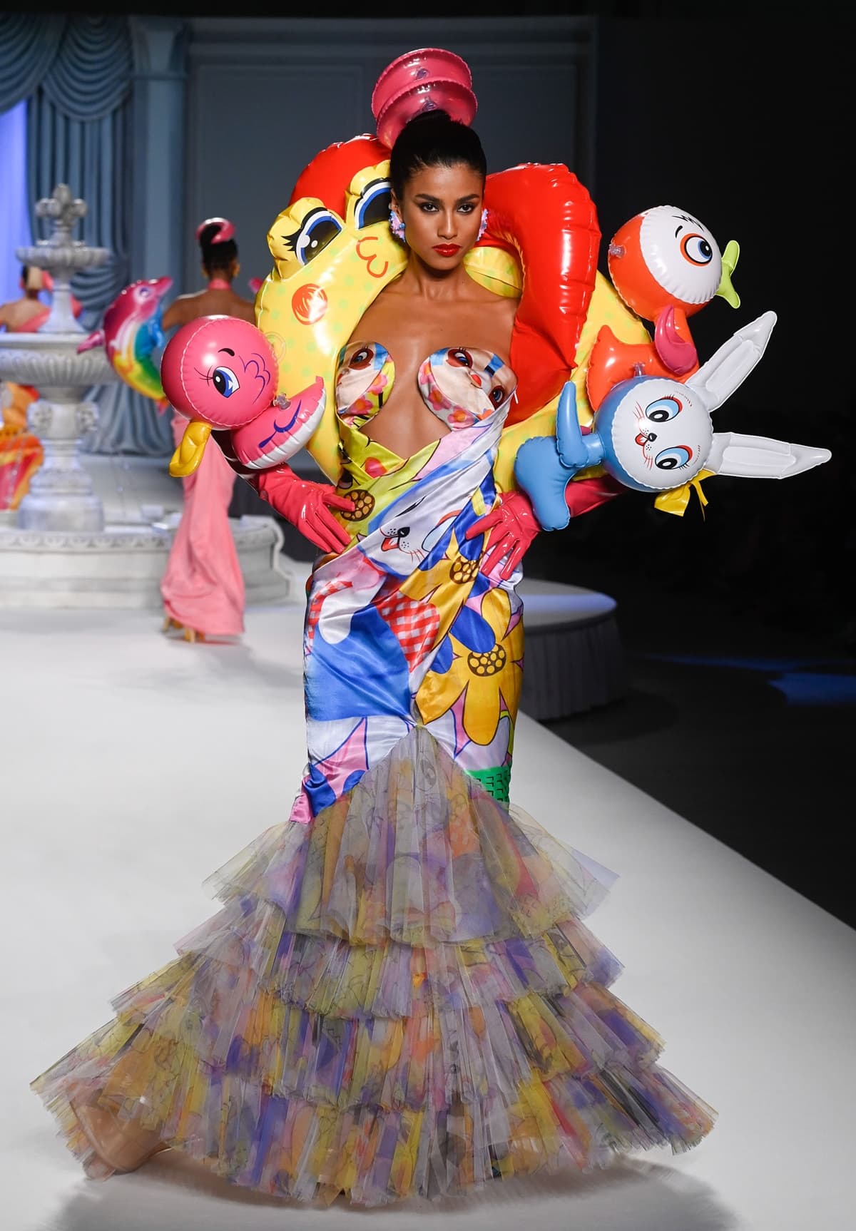 Moschino's Spring/Summer 2023 collection, "Inflation Chic," by Jeremy Scott, humorously addressed the global economic climate by incorporating inflatable pool toys and accessories into playful, joyous runway designs