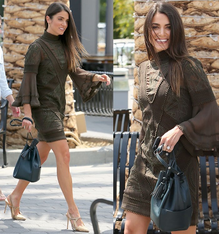 Nikki Reed wears a brown Asos dress on the set of "Extra"