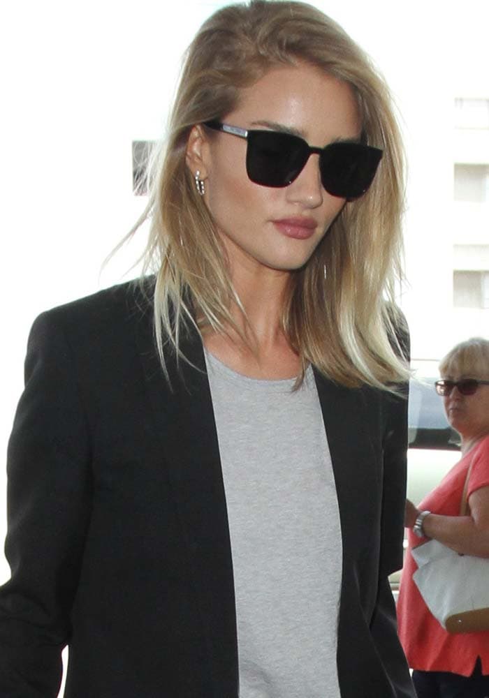 Rosie Huntington-Whiteley wears her hair down as she prepares to depart from the Los Angeles International Airport