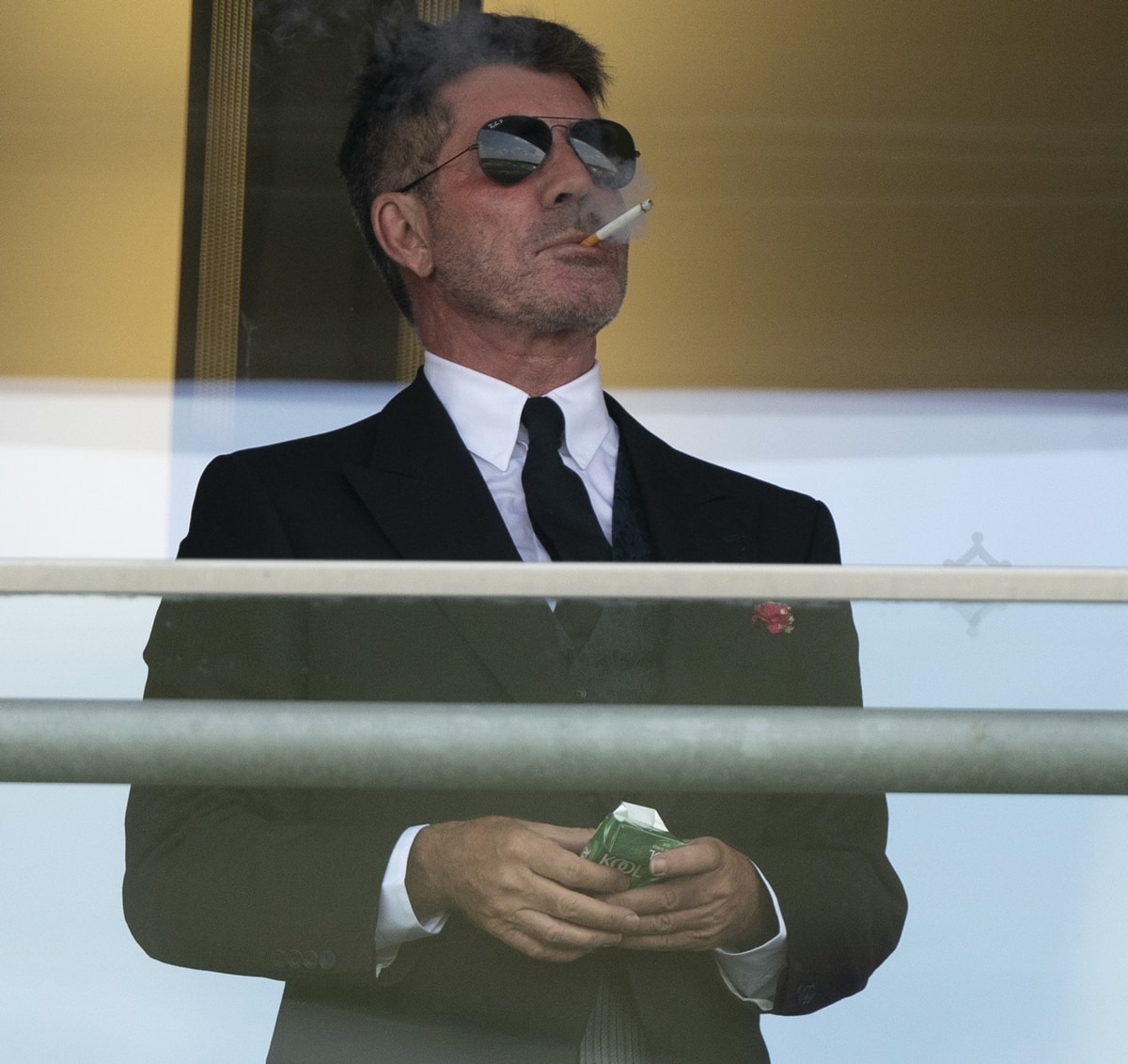 Simon Cowell smokes a Kool menthol cigarette on day one of Royal Ascot 2021