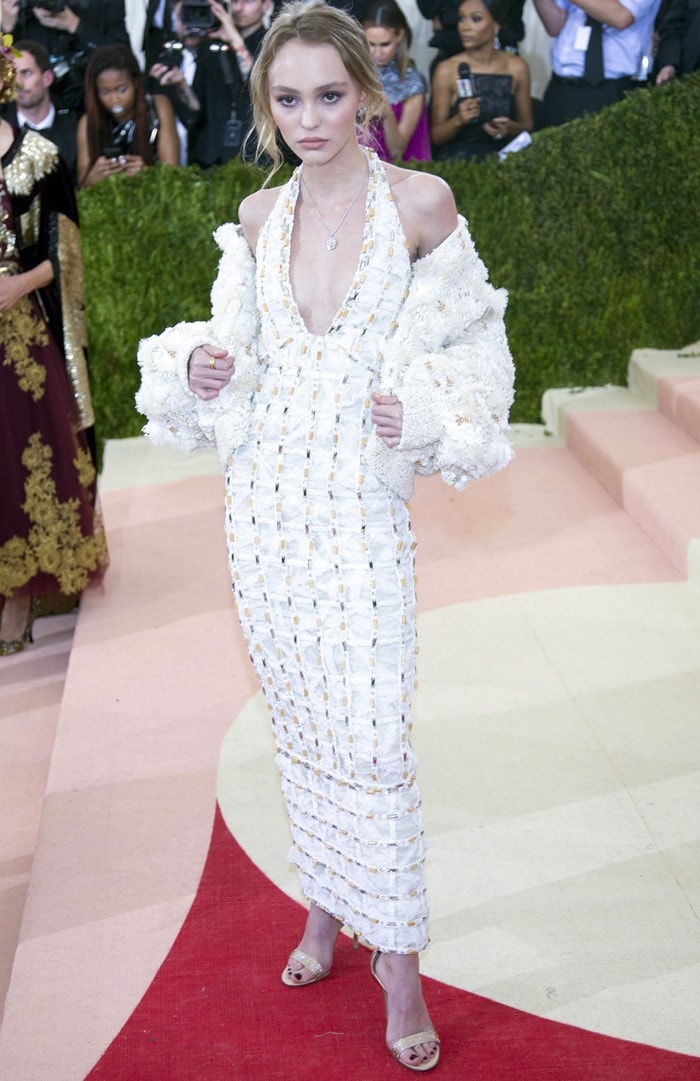 Lily-Rose Depp in a plunging white gown paired with an edgy oversized bolero jacket from the Chanel Spring/Summer 2016 Haute Couture collection