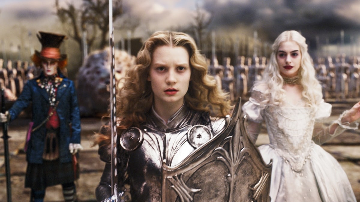 Johnny Depp as Tarrant Hightopp, the Mad Hatter, Mia Wasikowska as Alice Kingsleigh, and Anne Hathaway as Mirana of Marmoreal, the White Queen, in Tim Burton's 2010 American adventure fantasy film Alice in Wonderland