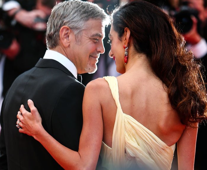 George Clooney and his wife Amal Clooney exchange a loving glance on the red carpet of the Cannes Film Festival