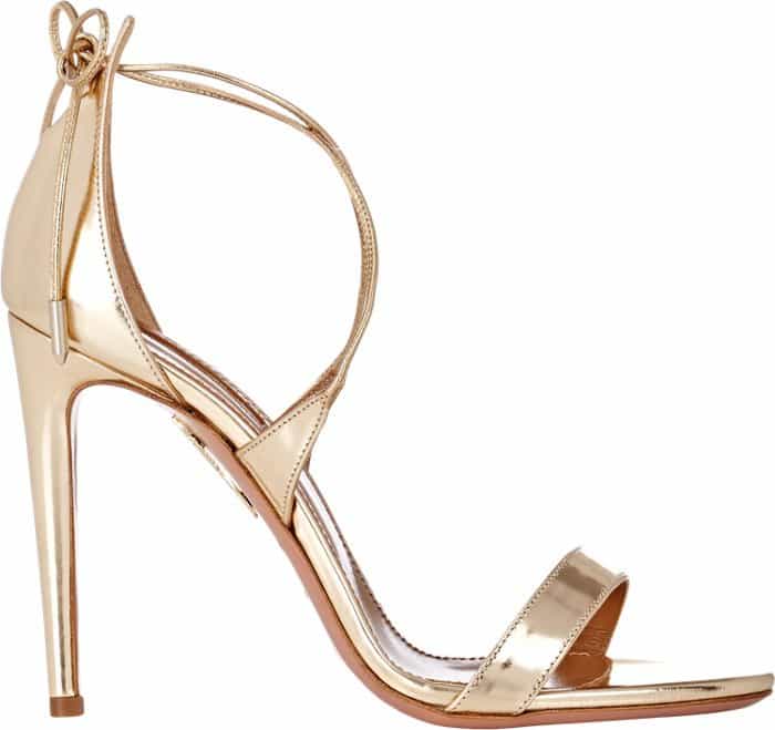 Gold-tone metallic leather Aquazzura Linda sandals with crossover straps at ankles, covered heels, and tie closures at ankles