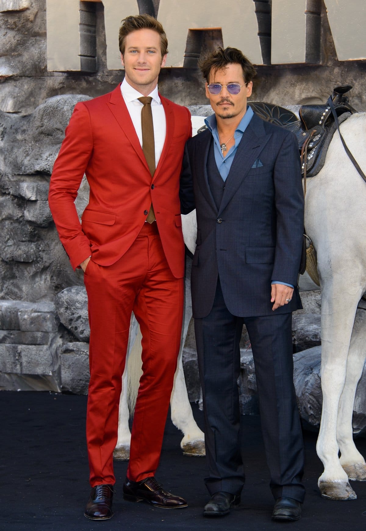 Johnny Depp looks short standing next to Armie Hammer, who measures 6′ 5″ (196 cm)