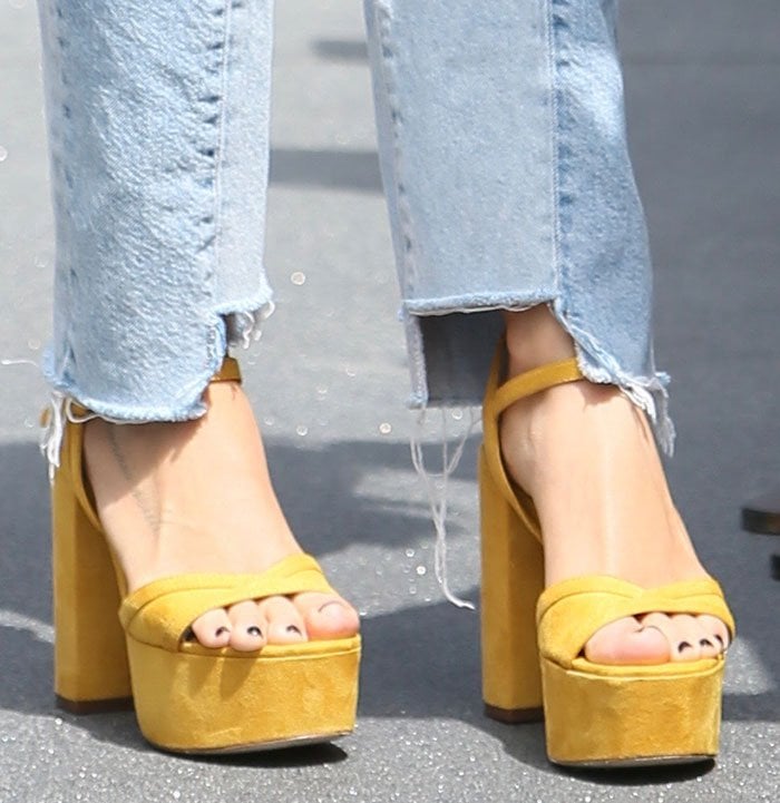 Ashley Tisdale displays her feet in yellow block heel shoes from Zara