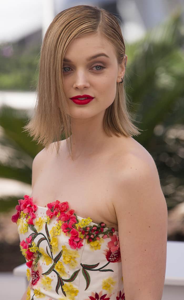 Bella Heathcote's choice of bold red lip provided a delightful contrast against the dress