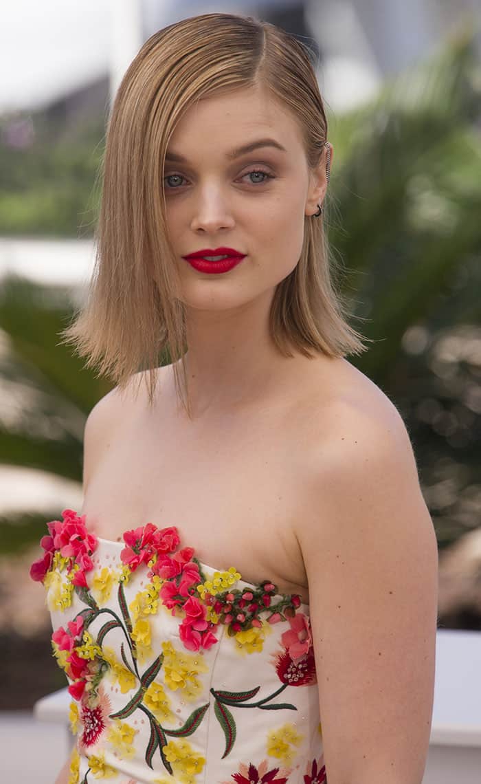 Bella Heathcote's choice of bold red lip provided a delightful contrast against the dress