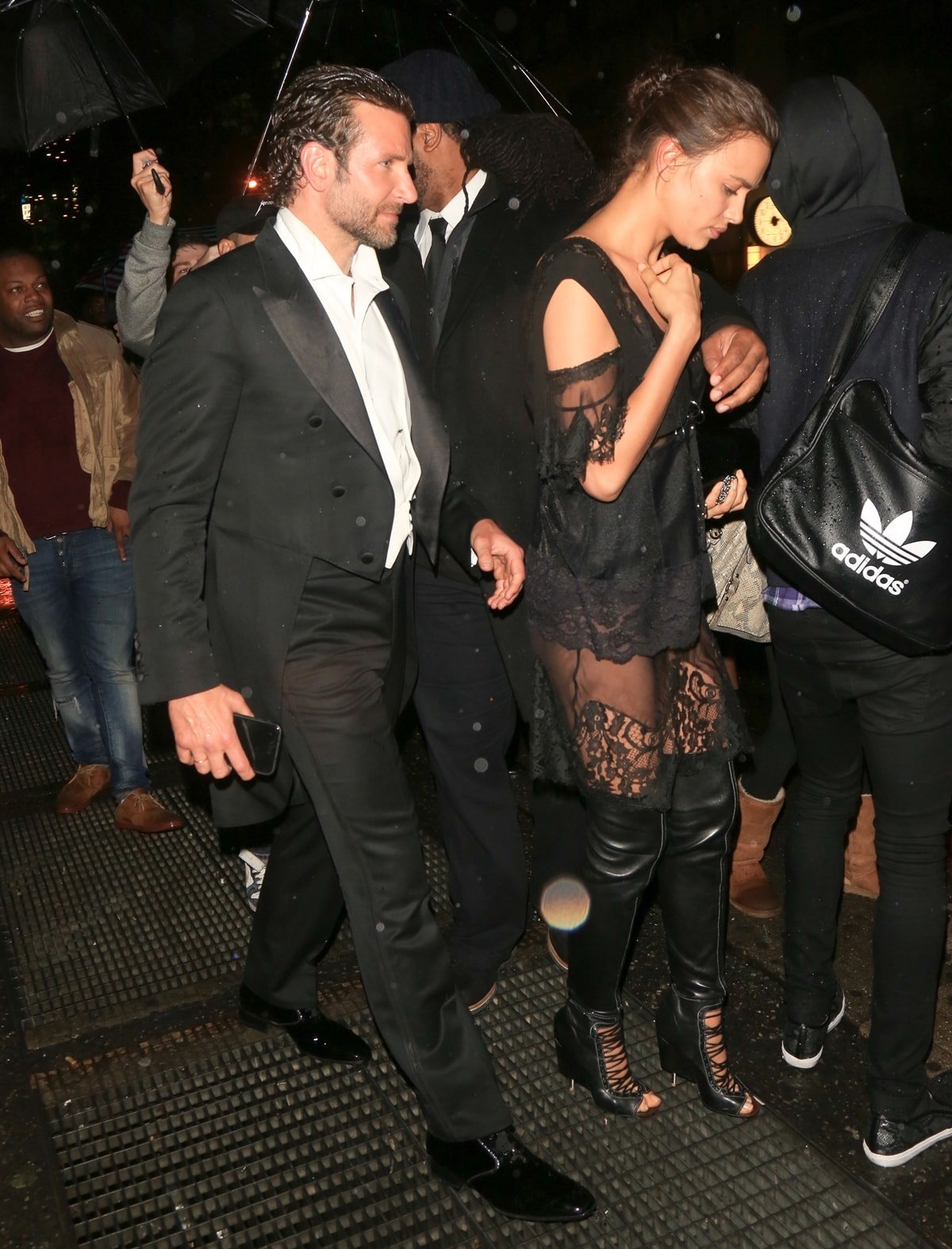 Bradley Cooper in a Tom Ford suit and Irina Shayk in a Givenchy outfit make their way into Up & Down nightclub after attending the 2016 Met Gala