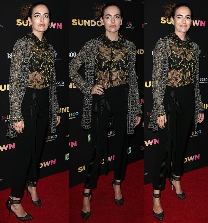Camilla Belle wears a sheer Monique Lhuillier blouse under a crystal-embroidered net cardigan