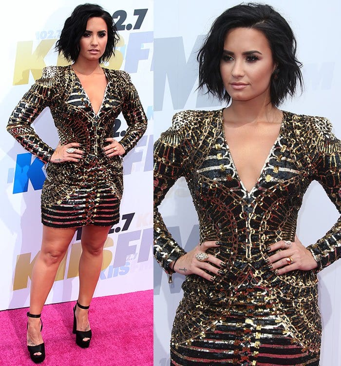 Demi Lovato wears a geometric-patterned sequined Balmain dress on the pink carpet