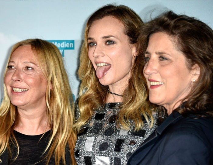 Joined by Director Fabienne Berthaud and Petra Mueller, Diane Kruger sticks her tongue out while posing on the red carpet premiere of "Sky"