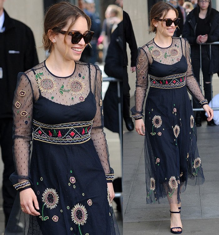 Emilia Clarke wears a beaded lace Valentino dress and dark sunglasses while heading to the BBC Radio 1 studios in London