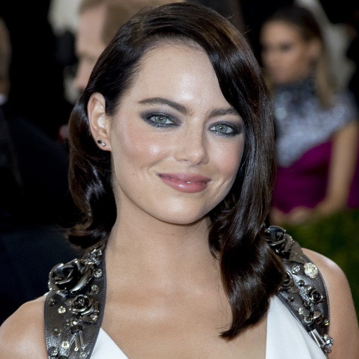 Emma Stone wears simple stud earrings and smoky eye makeup to the 2016 Met Gala