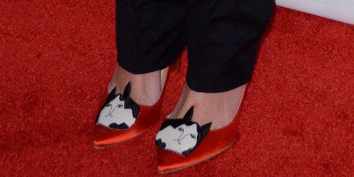 Georgia May Jagger's feet in red satin cat-design pumps